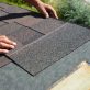 Asphalt Shingles Installation. Roofer Contractor Installing Asphalt Shingles on House Roofing Construction